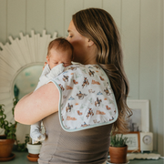 Parent holding baby with a Copper Pearl Boone burp cloth in cowboy print over the shoulder
