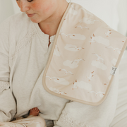 Parent holding baby with a Copper Pearl Fischer burp cloth in tan print over the shoulder