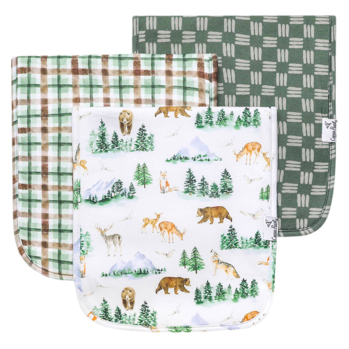 Three Grayson burp cloths stacked: forest animals print with two coordinating green plaids