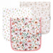 Three Natalie burp cloths laid flat in floral, ditsy floral, and woodland animal prints