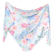 Copper Pearl knit swaddle blanket in Genevieve print, pink and blue florals, shown draped
