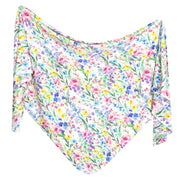 Copper Pearl knit swaddle blanket in Josie print, colorful wildflowers on white, shown draped
