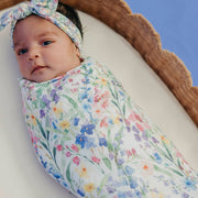 Close-up of a baby wrapped in the Copper Pearl Josie wildflower knit swaddle blanket