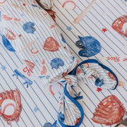Close-up of the knotted bottom and navy trim on the Copper Pearl All Star newborn gown
