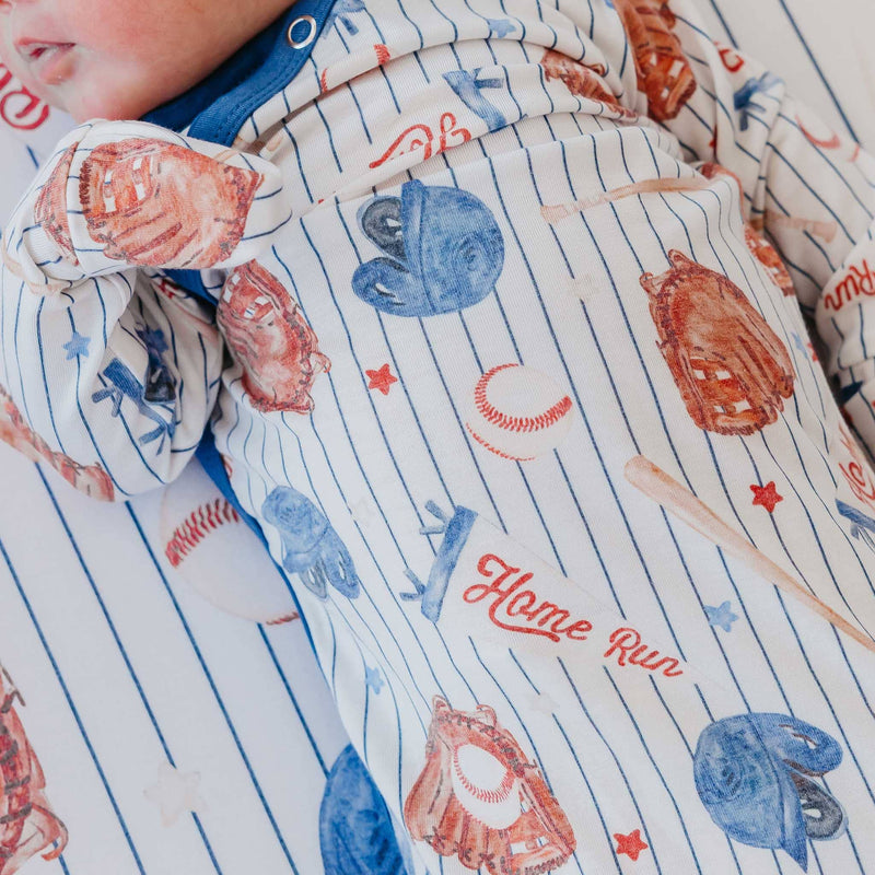 Close-up of the Copper Pearl All Star baseball print on the newborn knotted gown