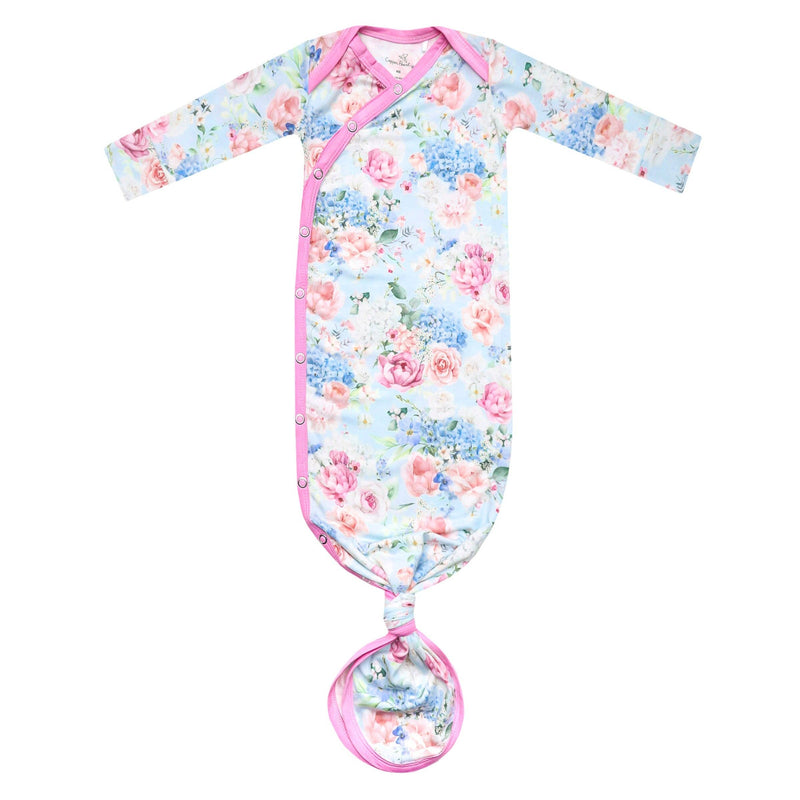 Copper Pearl newborn knotted gown in Genevieve print, pink and blue florals with pink trim, laid flat