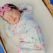 Close-up of a sleeping newborn wearing the Copper Pearl Genevieve floral knotted gown