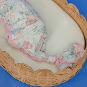Close-up of the knotted bottom and pink trim on the Copper Pearl Genevieve newborn gown