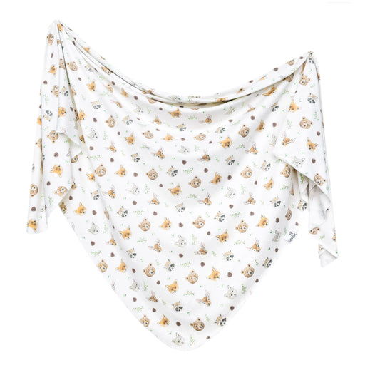 White jersey knit swaddle blanket laid out flat with woodland animal print