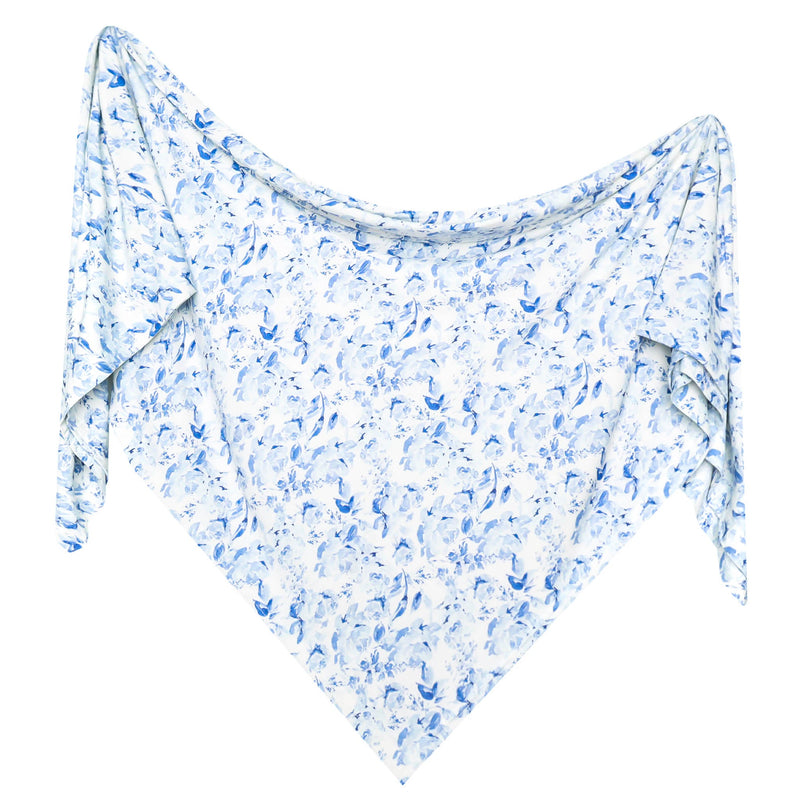 A lightweight baby swaddle blanketwith a delicate blue floral and leaf pattern on a white background, displayed against a solid white backdrop.