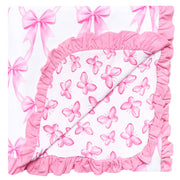 A square baby blanket or quilt with a white background, decorated with pink watercolor butterflies and bows, finished with a thick pink ruffled border.