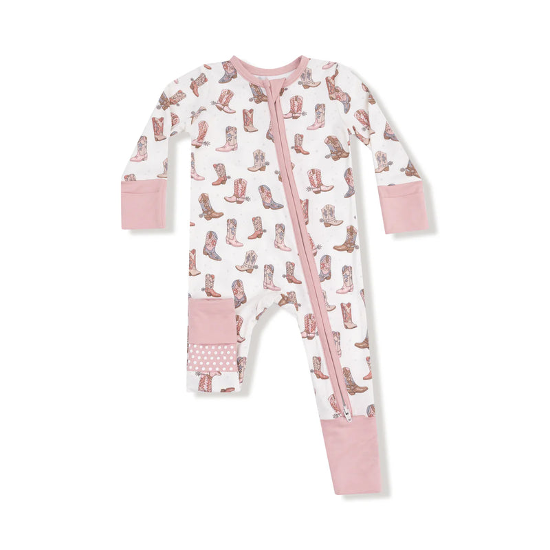 Flat lay of the romper with pink trim and cowgirl boot print.