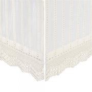 White lace curtain with scalloped edge on a white background