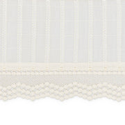 Close-up of a textured white fabric with a subtle pattern on a white background