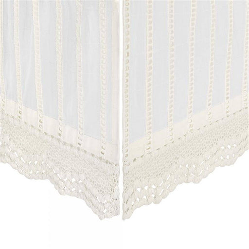 White lace curtain with scalloped edge on a white background