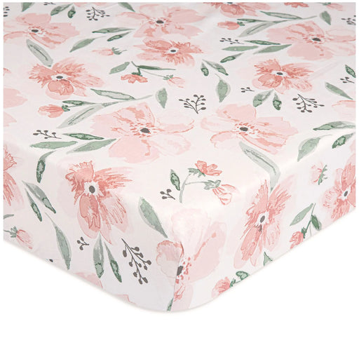 Close-up of Parker Floral fitted crib sheet with pink watercolor flowers and green leaves