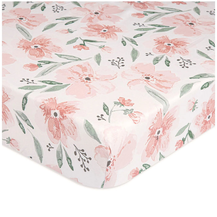 Close-up of Parker Floral fitted crib sheet with pink watercolor flowers and green leaves