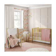 Nursery room setup with Parker Floral bedding, natural wood crib, and soft pink décor