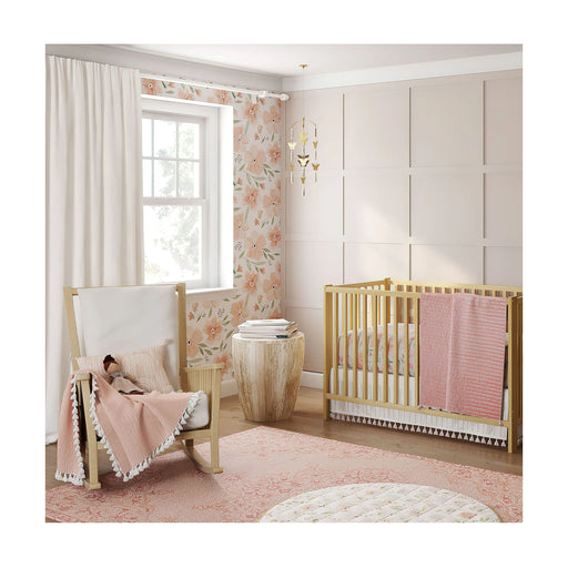 Nursery room setup with Parker Floral bedding, natural wood crib, and soft pink décor
