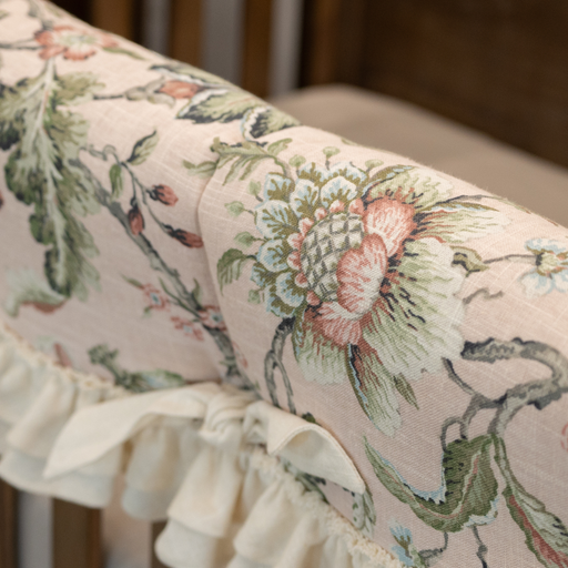 Floral patterned fabric with ruffled edge on a neutral background