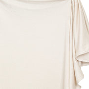 Close-up of the drape of the Lou Lou & Co Dakota cream plush knit swaddle blanket