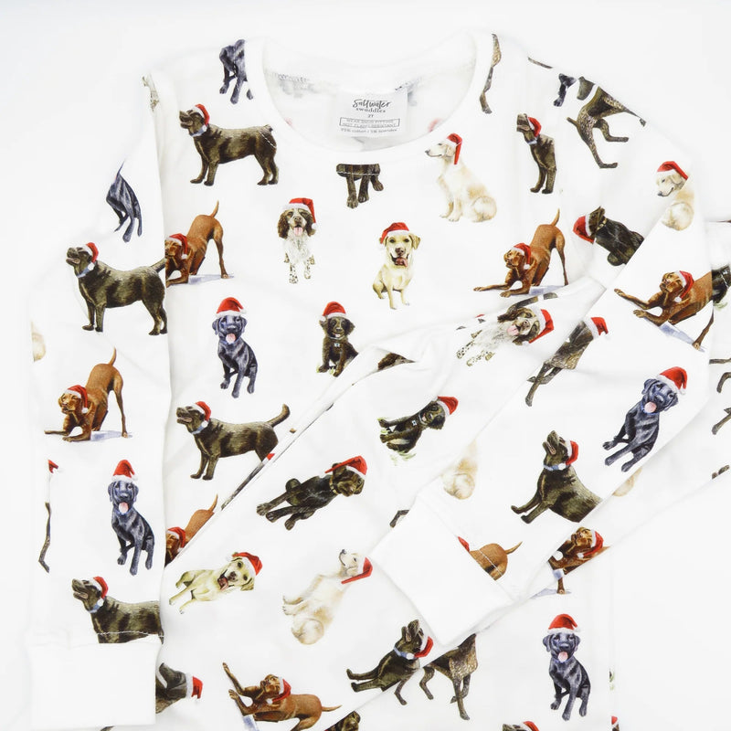 Closeup of Saltwater Swaddles Santa Dogs kids pajamas with watercolor holiday dog illustrations on white background