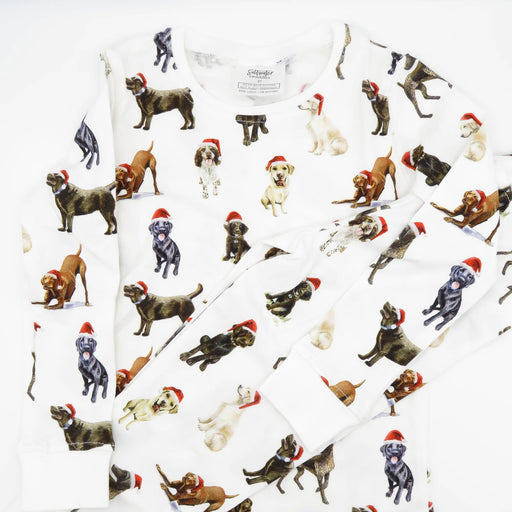 Closeup of Saltwater Swaddles Santa Dogs kids pajamas with watercolor holiday dog illustrations on white background