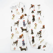 Flatlay of Saltwater Swaddles Santa Dogs kids pajamas with watercolor holiday dog illustrations on white background