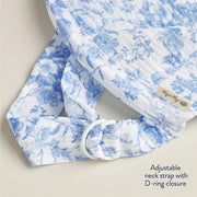 Close-up of the Itzy Ritzy nursing cover's adjustable neck strap with D-ring closure in blue floral muslin