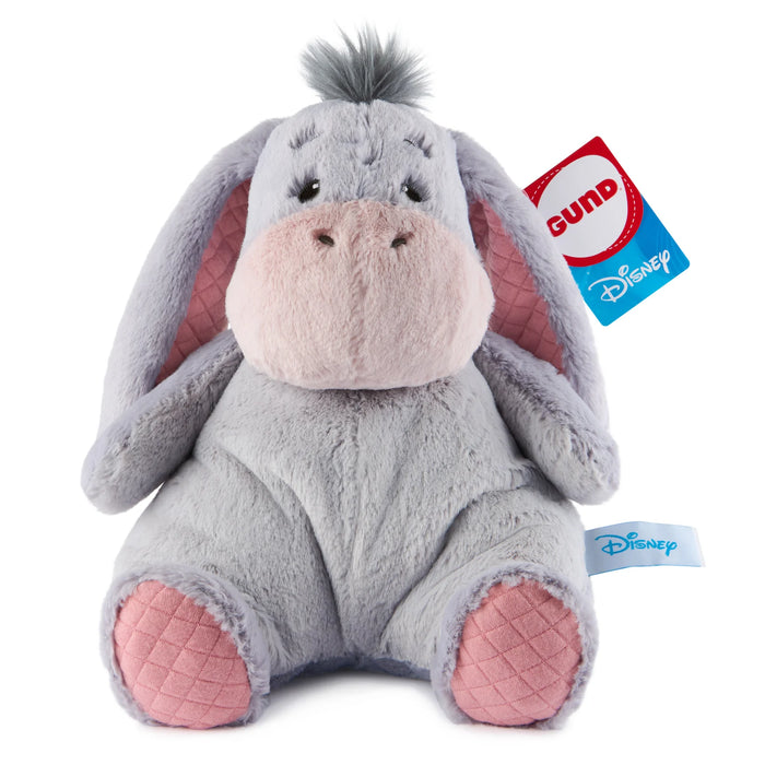 Plush toy resembling a donkey with pink ears and feet, featuring a GUND tag on a white background.