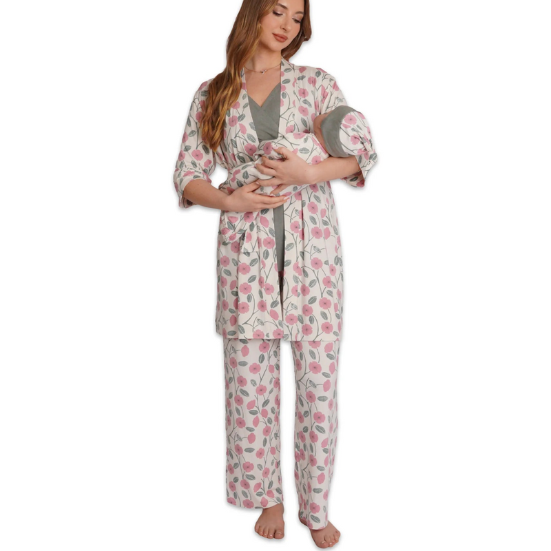 Woman wearing a floral robe and pajama set holding a baby on a white background