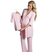 Woman wearing a pink robe holding a matching robe on a hanger against a white background