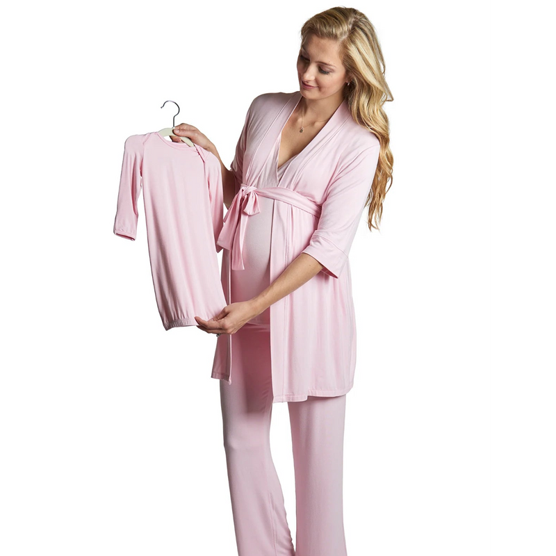 Woman wearing a pink robe holding a matching robe on a hanger against a white background