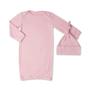 Pink baby gown and hat set on a white background