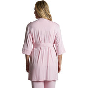 Person wearing a pink robe and pants set on a white background