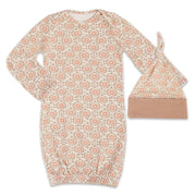Floral patterned baby gown and hat set on a white background