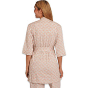 Woman wearing a pink patterned outfit on a white background