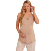 Woman wearing a beige sleeveless top and patterned pants on a white background