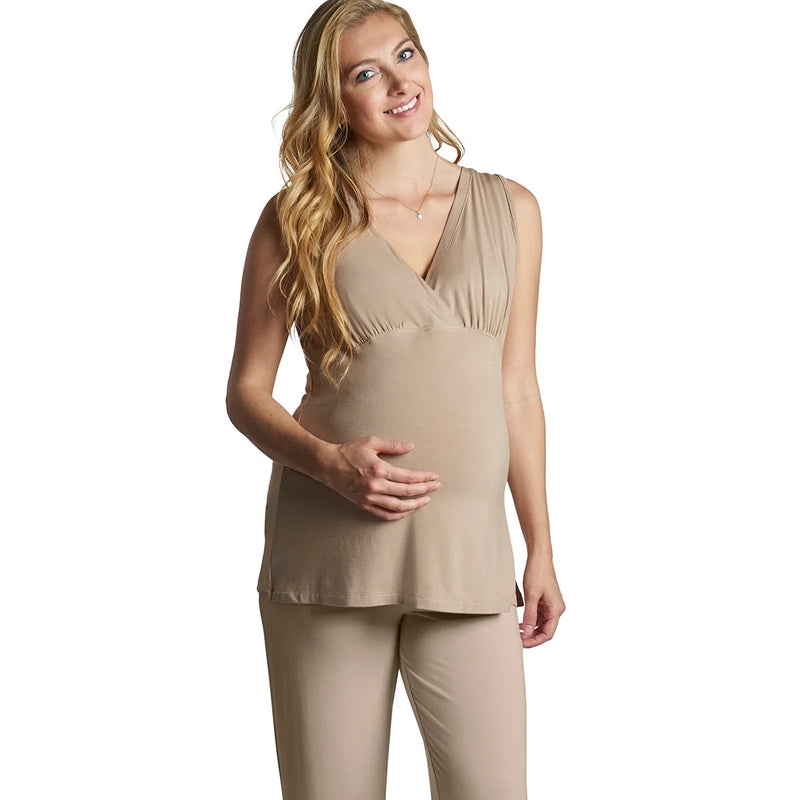 Woman wearing a beige maternity outfit on a white background