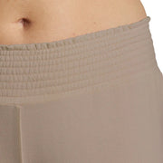 Close-up of beige pants with a white background