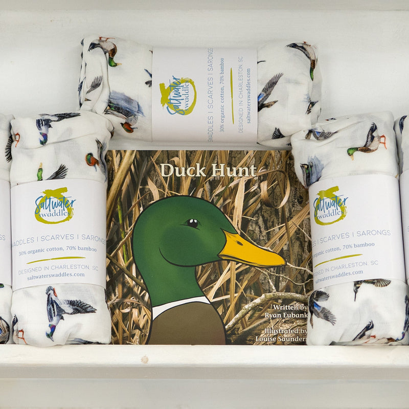 Duck Hunt Mossy Oak Edition board book displayed with duck print swaddle blankets
