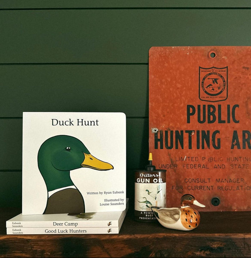 Duck Hunt board book displayed on a shelf with a duck decoy