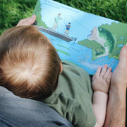 Child reading the largemouth bass page of Good Luck Fishermen