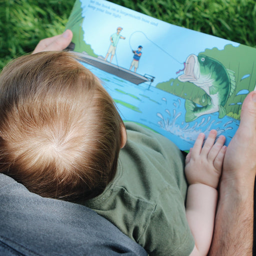 Child reading the largemouth bass page of Good Luck Fishermen