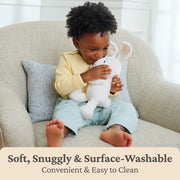 Child cuddling Flora the Bunny 7 inch plush on a couch