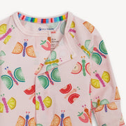 Baby onesie with colorful fruit and caterpillar pattern on a white background