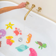 Guppy Grips ocean-themed non-slip stickies applied to the bottom of a white bathtub