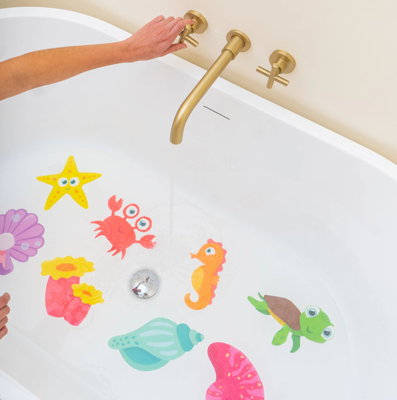 Guppy Grips ocean-themed non-slip stickies applied to the bottom of a white bathtub