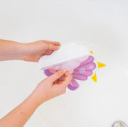 Hands applying a Guppy Grips non-slip sticky to a bathtub