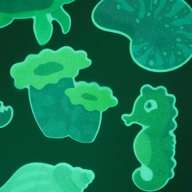 Guppy Grips seahorse, coral and shell bath stickies glowing green in the dark